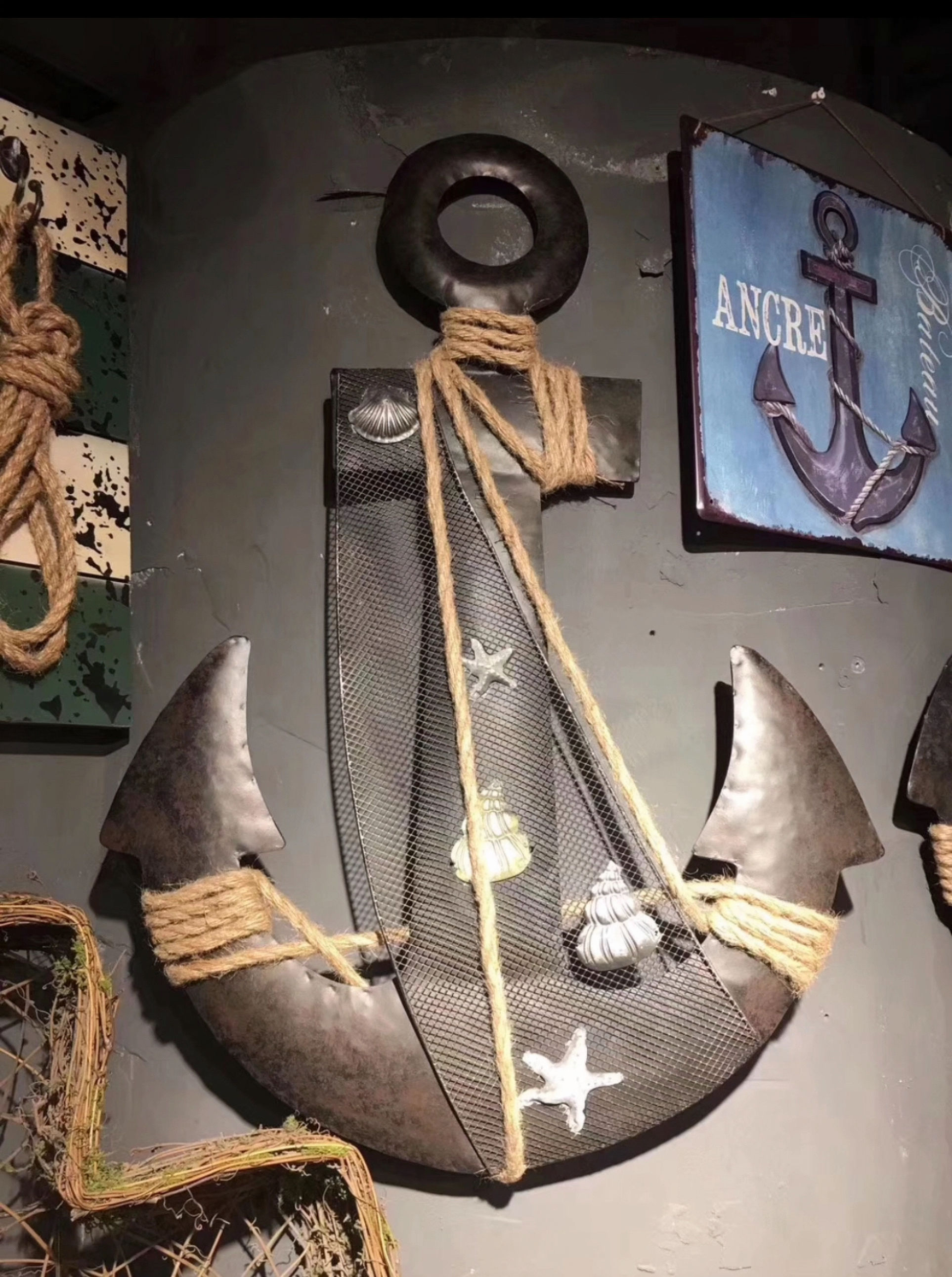 Decorative anchor wrapped in rope with nautical symbols