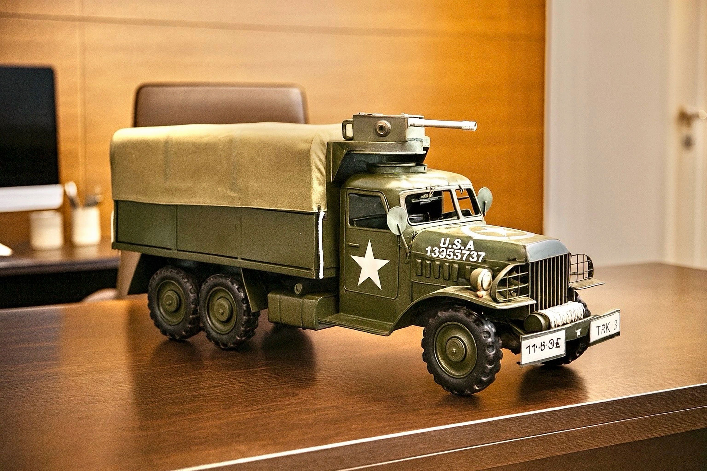 Green military truck model with canvas cover and turret gun