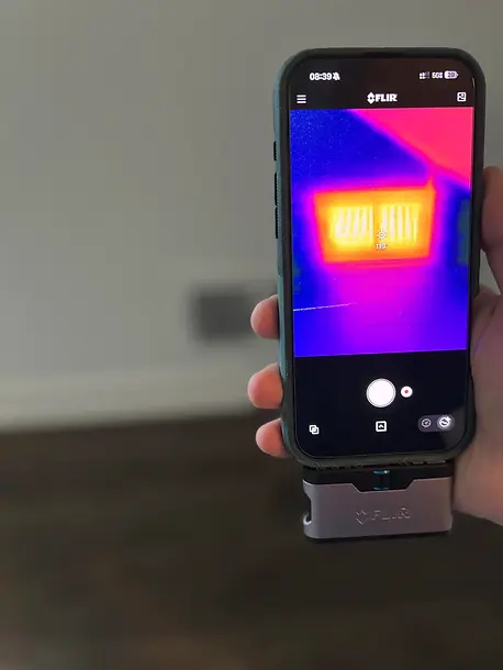 Tucker, GA home inspector using thermal camera to verify HVAC temperature.