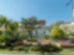 Résidence 21 in Larvotto, modern luxury apartments with elegant facade and palm trees in front, close to the beachfront