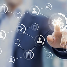 As if looking through a pane of glass, a man touches a series of gears that are connected to other icons related to workflows, such as people and checklists.