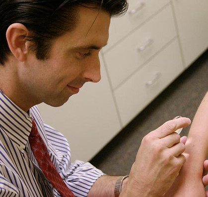 Dermatologist Checking A Mole