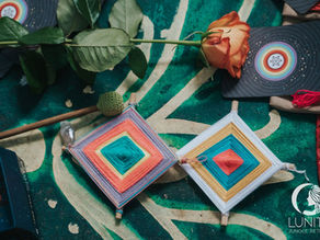 Colorful handcrafted gifts featuring vibrant yarn designs and a rose are prepared for participants at the Lunita Jungle Retreat Center in Cancún, Mexico.