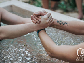 Supporting hands share strength and connection during an ice bath at Lunita Jungle Retreat, Riviera Maya, Mexico.