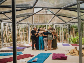 Team members share a warm embrace during a reflective moment at a corporate retreat in the serene Lunita Jungle Retreat Center, Mexico.