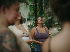 A group of individuals practices mindfulness and relaxation amidst the lush greenery at a corporate retreat in Lunita Jungle Retreat Center, Riviera Maya, Mexico.