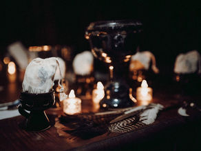 A beautifully arranged gift at the Lunita Jungle Retreat Center in Mexico, featuring a small, intricately designed bag accompanied by natural elements and soft candlelight, creating an inviting and serene atmosphere for retreat participants.