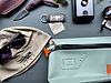 Outdoor gear: knife, Sitka hat, sunglasses, and waterproof bag