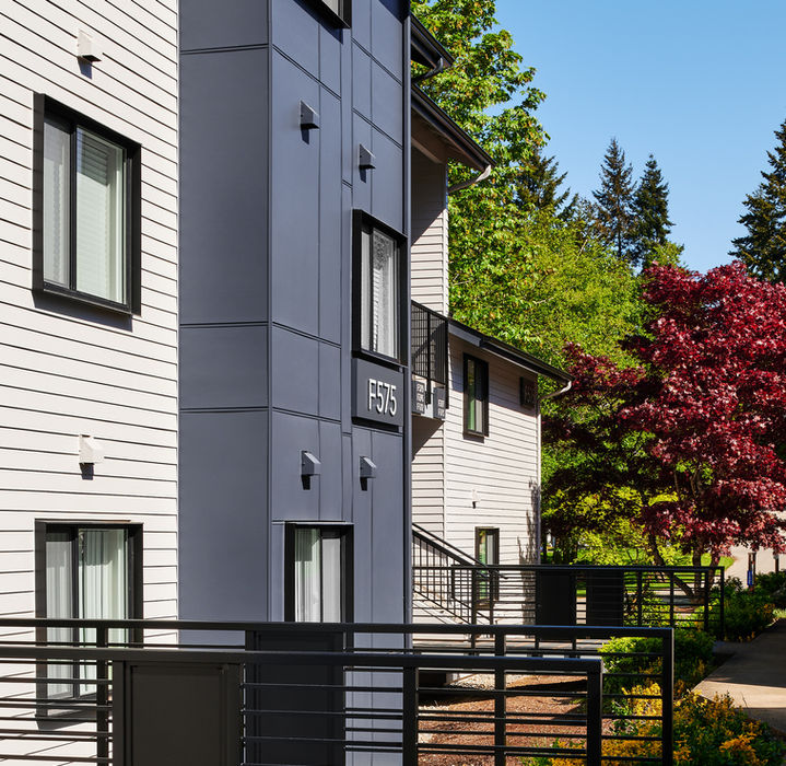 Exterior view of a modern apartment building with various windows and design.