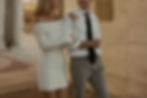 Couple strolling, holding hands, elegantly dressed