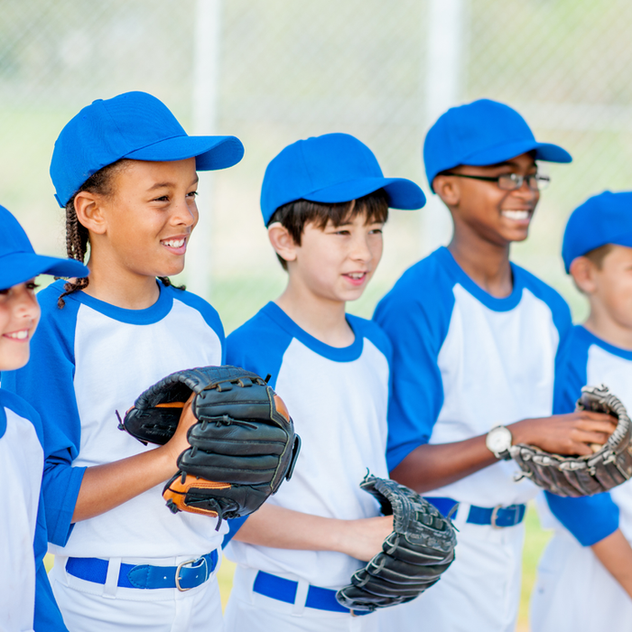 Youth baseball team in blue uniforms and mitts