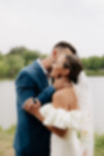 Happy couple embraces by lake