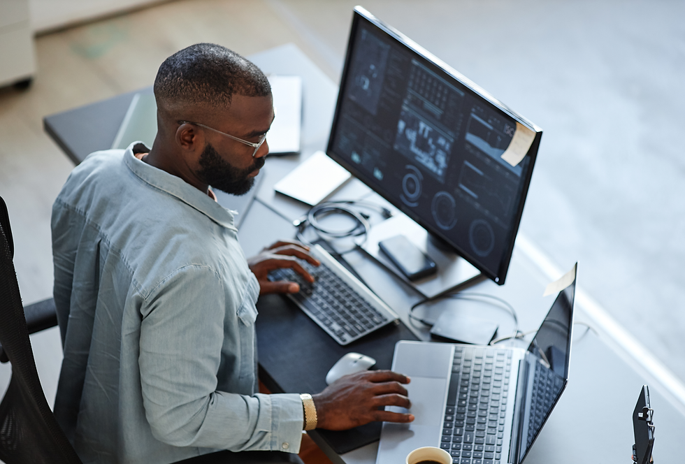 Developer managing CI/CD pipelines on dual monitors.
