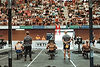 Athletes resting at "Pista 2" with YETI cooler, spectators watch.
