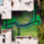 Aerial view of a complex green roof system with black pathways.