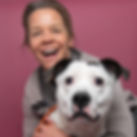 Cheerful woman with her dog against a pink background, capturing warmth, authenticity, and positive human connection
