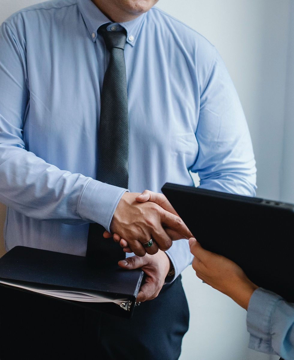 Business partners shaking hands while closing a deal.