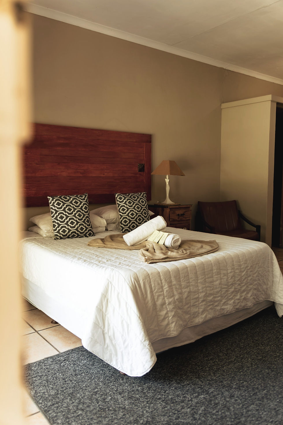 Comfortable double room at Crocodilian Hotel in Fochville with neatly prepared bed and warm interior