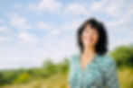 Smiling woman in a sunlit landscape.jpeg