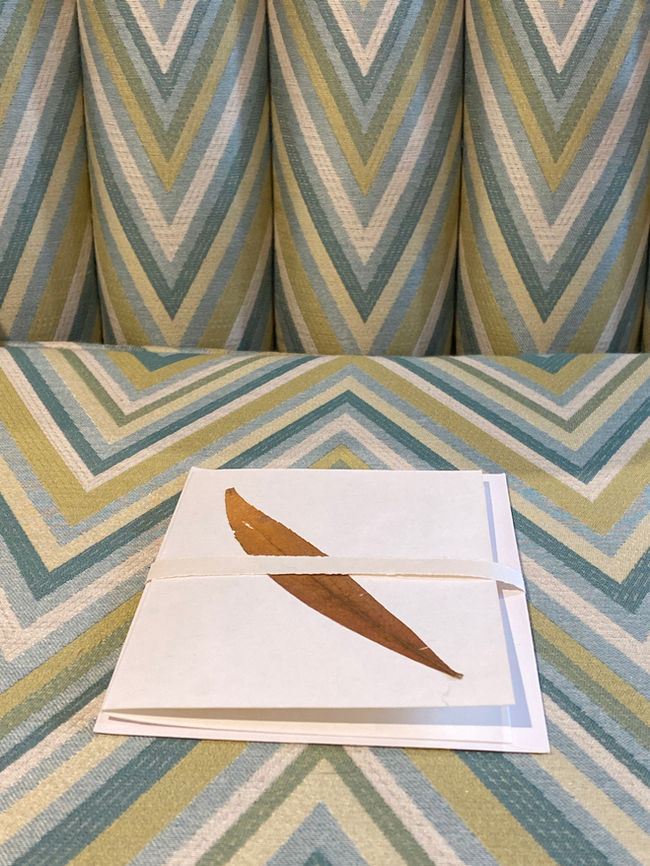 1940s Parker Knoll fluted Bentwood chair sold at the Seated View Missoni inspired fabric in greens and blue shown with handpressed leaf card