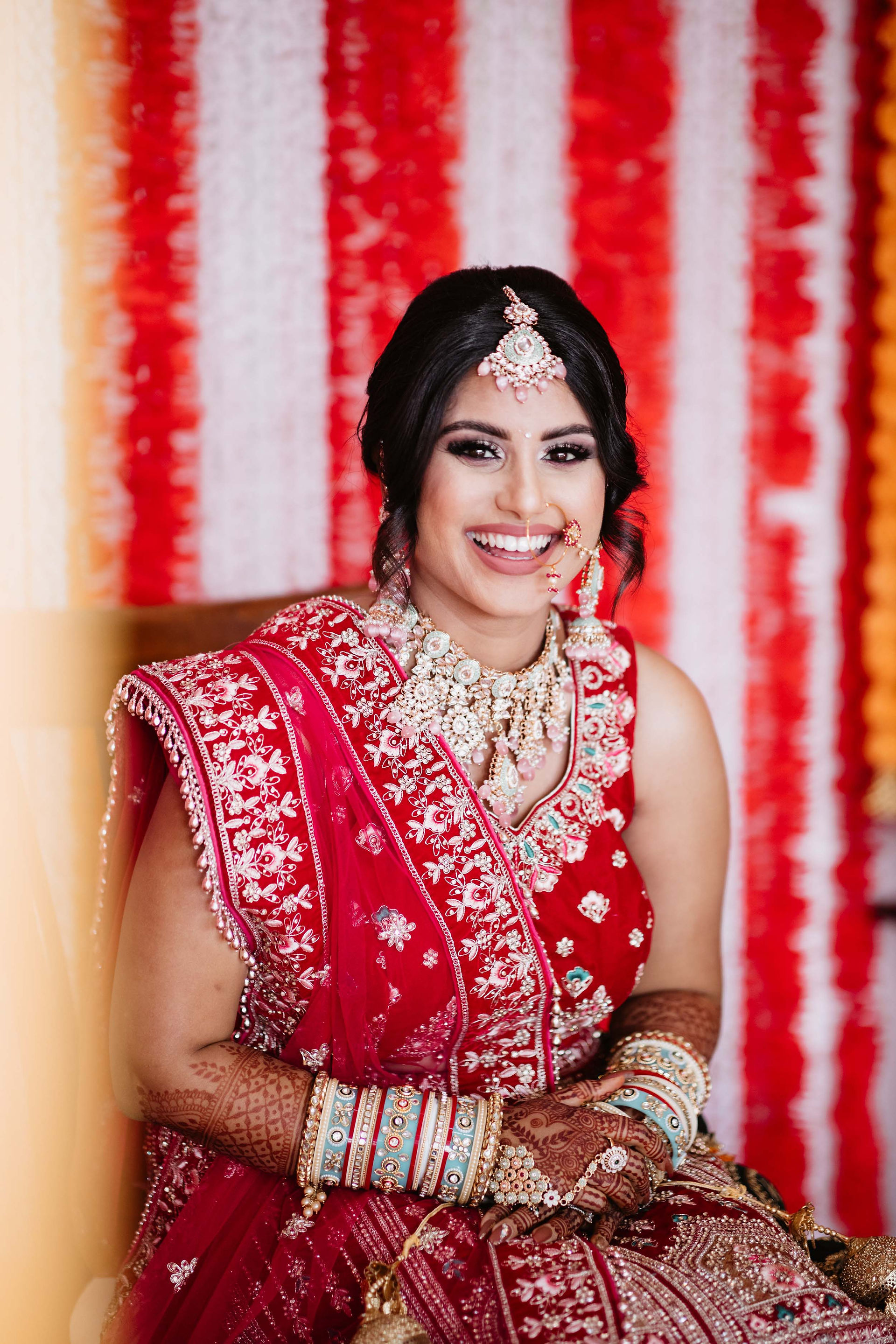 fijian indian bride smiling sari pink gold jewellery 