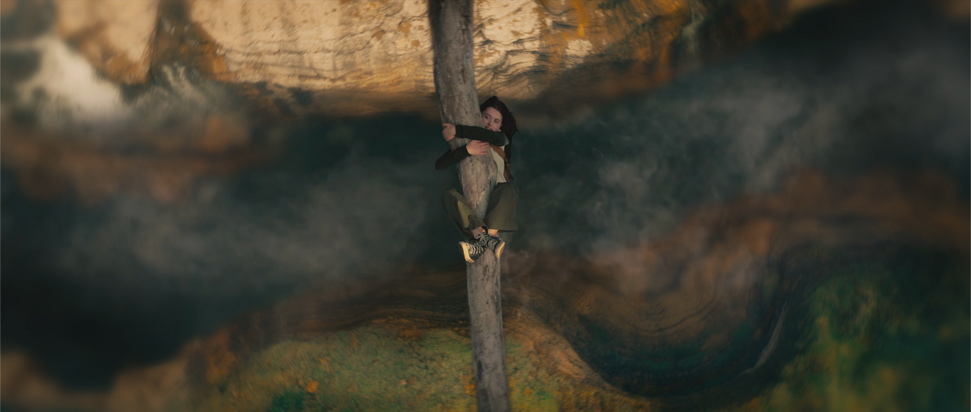 teen girl hanging from log suspended over chasm fantasy gorge vfx short film