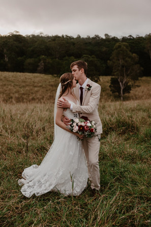 groom kissing brides forehead in outback country queensland
