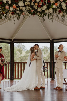 bride and groom kissing at ocean view estates winery wedding pagoda