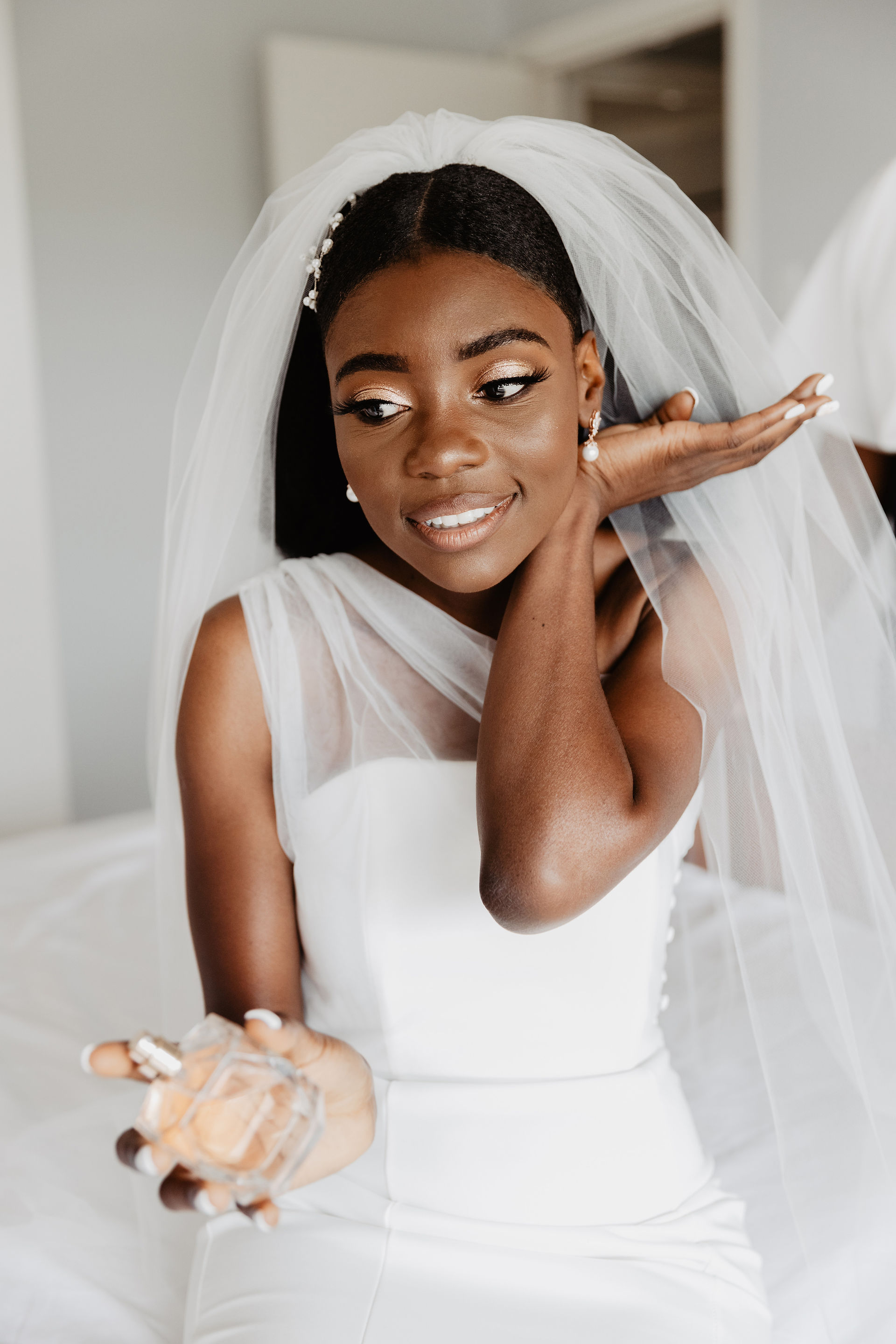 african bride spraying perfume getting ready for wedding