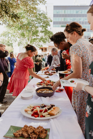 wedding guests grazing on food platters outside