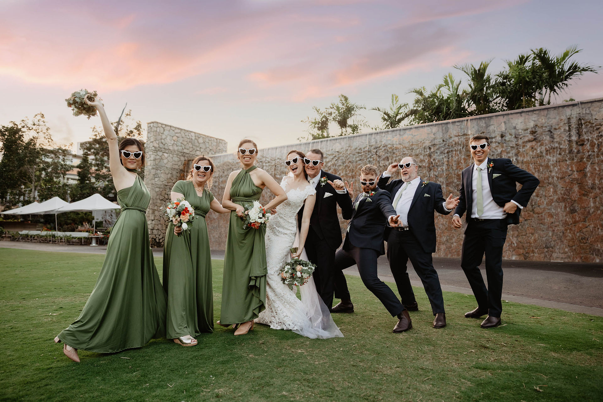 fun group shot roma st park waterfall sunset bridesmaids and groomsmen