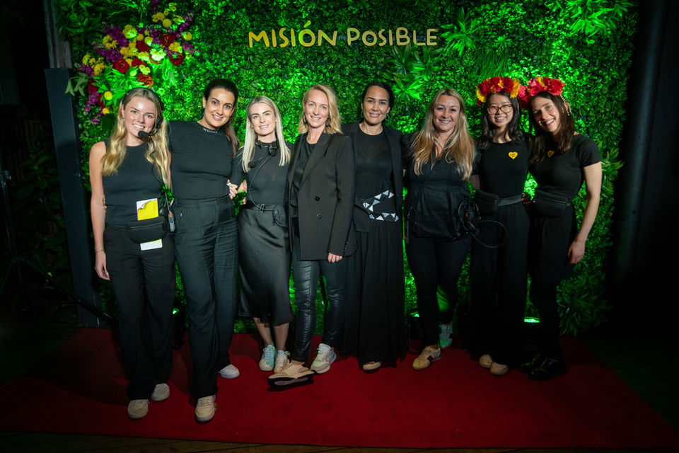 Nine members of the Usual Suspects team at a charity event 