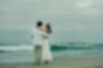 Couple on beach, woman looking at man