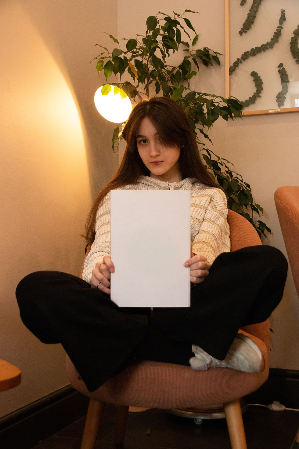woman in white knit sweater holding white paper_edited.jpg