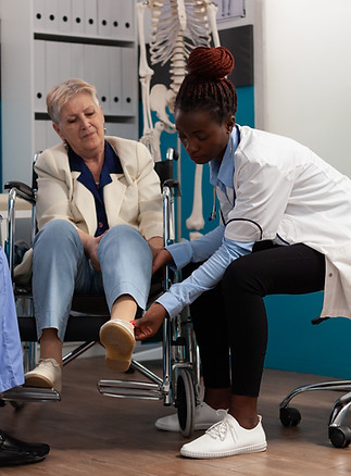 Healthcare provider examining an older adult’s lower leg during clinical training