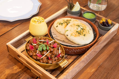 Indian food platter with chana masala, naan bread, and chutney
