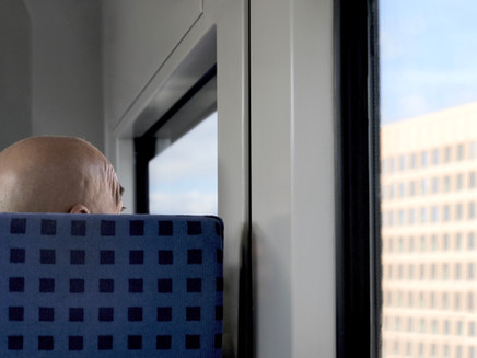 chequered seat cover in the train, matching the window facade outside