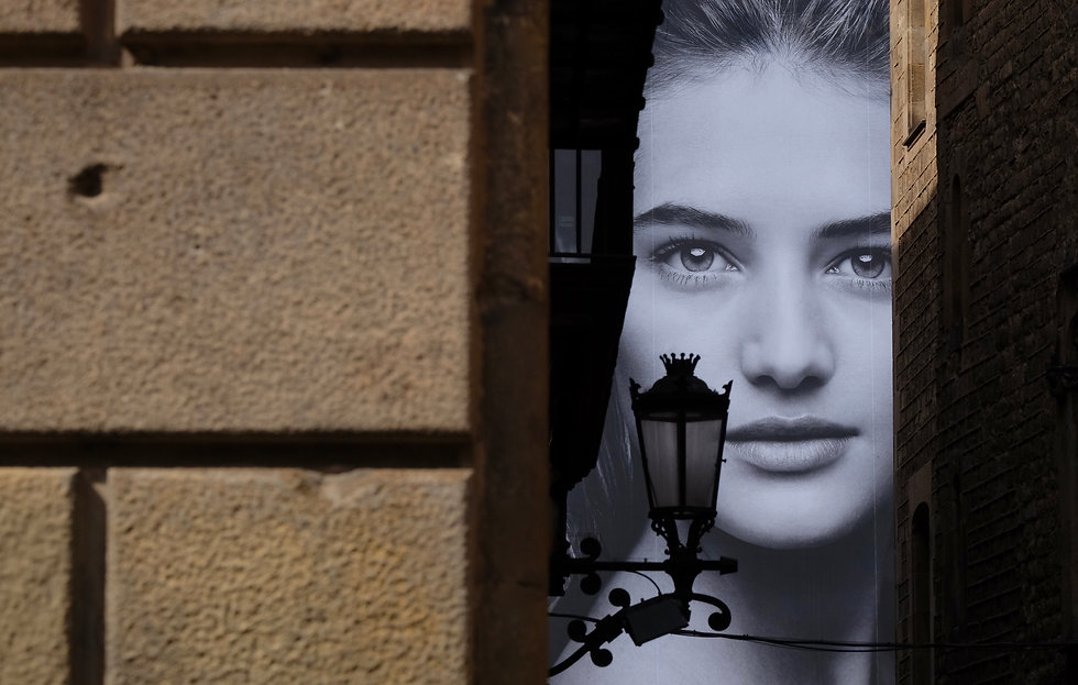 Old town and large female face on poster