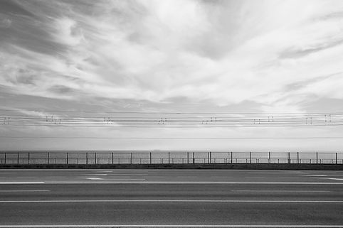 a street, a fence and the sea in the background, entry to the MONO BLEND image collection