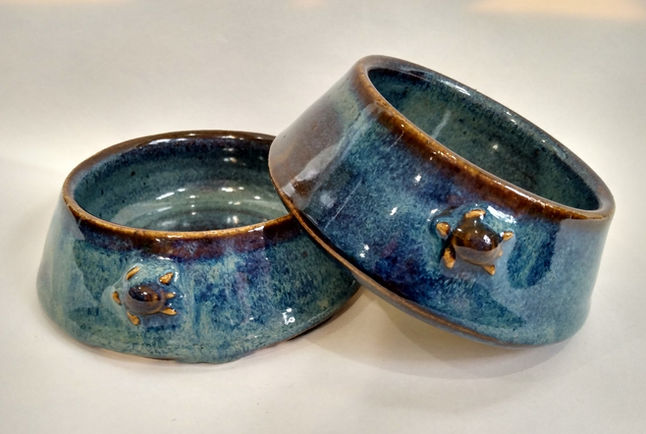 Blue and sienna colored cat bowls made by Sheena Montane.