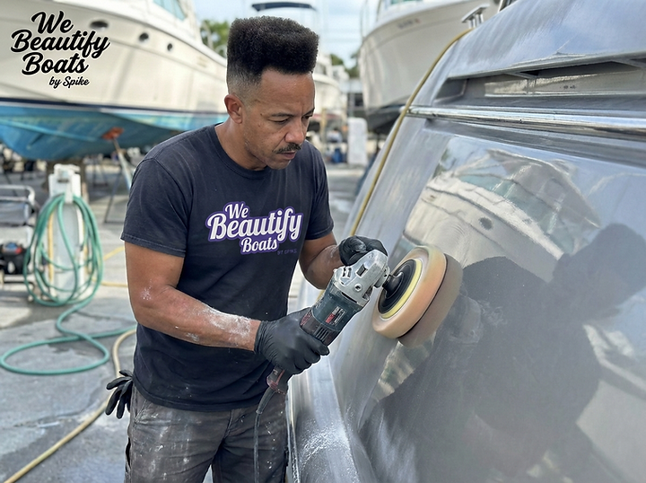 Close-up image of a marine technician performing machine polishing on a boat’s fiberglass hull in a professional boatyard environment. The technician is using a rotary buffer with a foam polishing pad, working along the curved surface of the topsides to restore gloss and remove light oxidation. The gelcoat shows visible haze being refined to a smoother, more reflective finish. Nearby boats on stands and hoses in the background reinforce the working marina setting. The We Beautify Boats by Spike logo is positioned on the technician’s shirt and in the upper left corner. The image represents a Level 2 hull polishing service focused on oxidation removal, gloss restoration, and surface refinement. Service by We Beautify Boats by Spike, Boat Detailing, Toronto, Ontario, Canada.