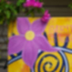 Close-up of mystical eye motif and vibrant purple flowers in Divine Alignment by Electric Vizion, visionary art detail