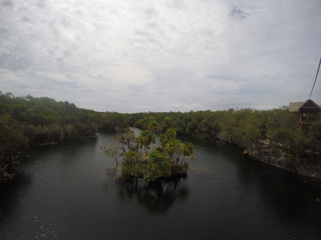 Mini island surrounded by the crystal-clear waters of the Tankah jungle lagoon.