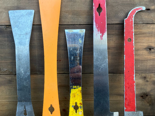 A collection of beekeeping hive tools