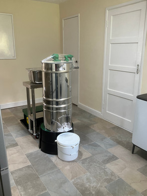 Jem's manual honey extraction line in the middle of the kitchen