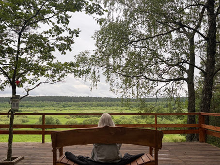 Woman sitting on a deck at a retreat.