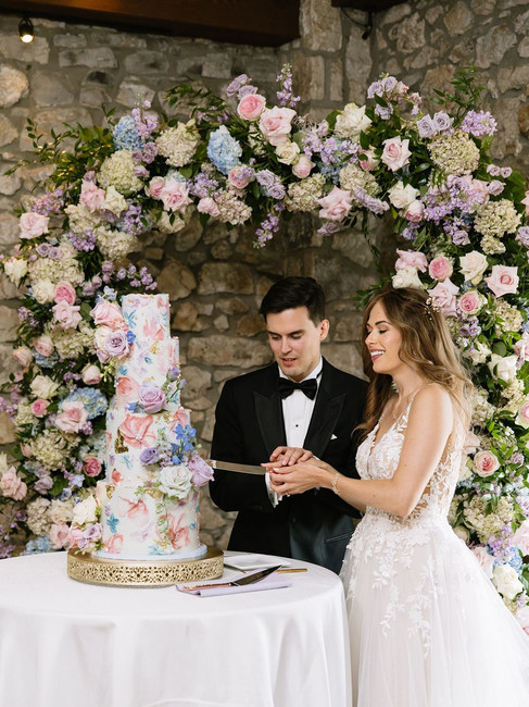 Bride and groom cut cake at Clinton OH wedding.