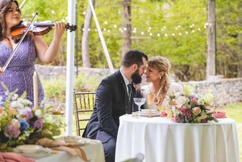 wedding couple enjoying live Bridgerton music at wedding reception