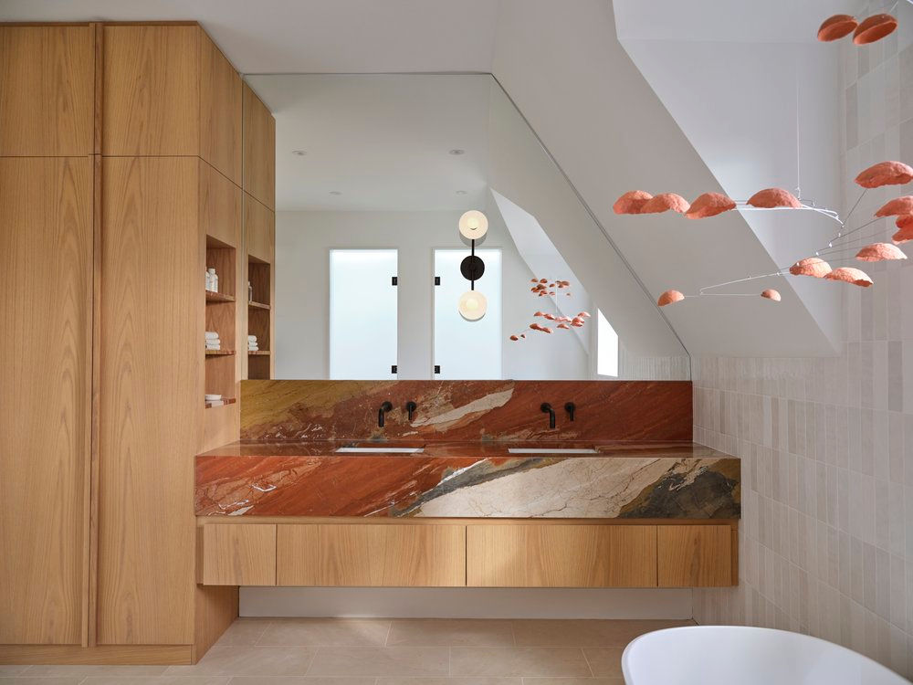 Modern bathroom with marble vanity and wood cabinetry