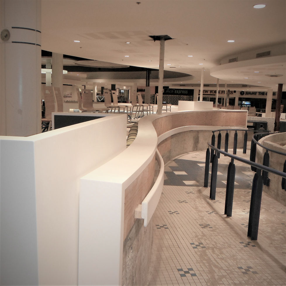 Modern curved white railings in a commercial food court